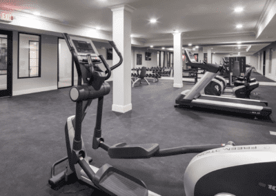 A modern gym equipped with treadmills and ellipticals.