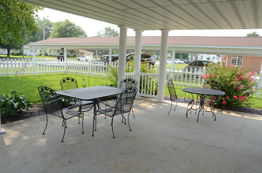 A welcoming outdoor patio space with metal tables and chairs, perfect for dining or relaxation.