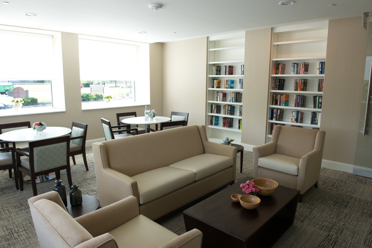 A modern library interior with comfortable seating and bookshelves.