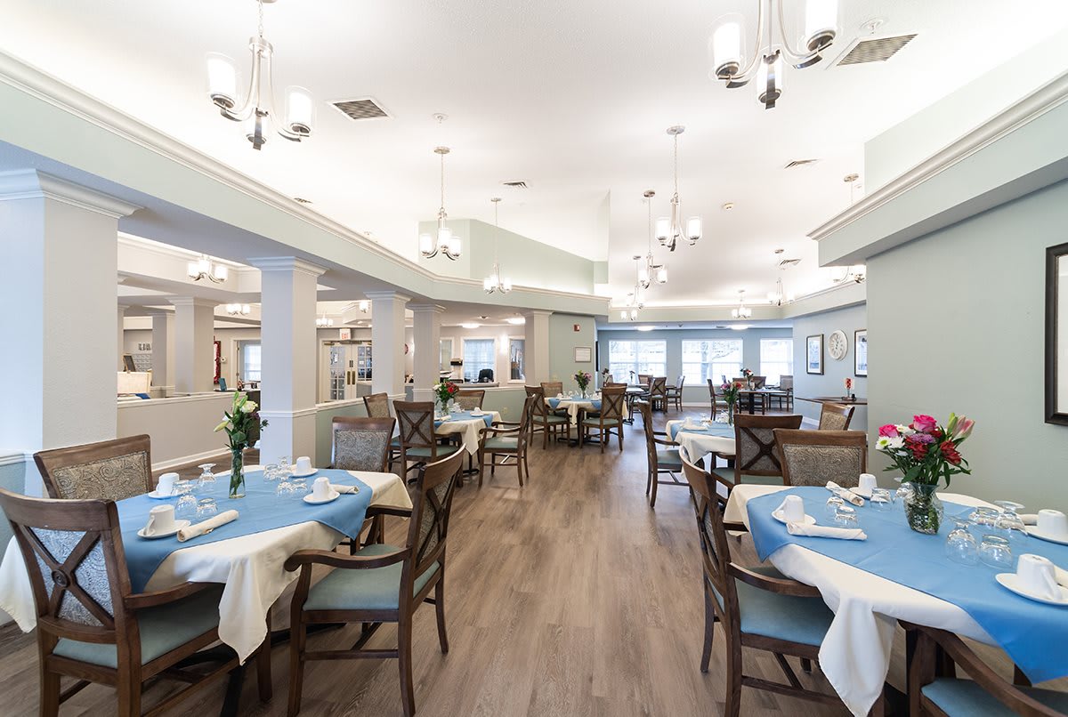 A spacious and elegantly designed restaurant dining area with neatly arranged tables and chairs.