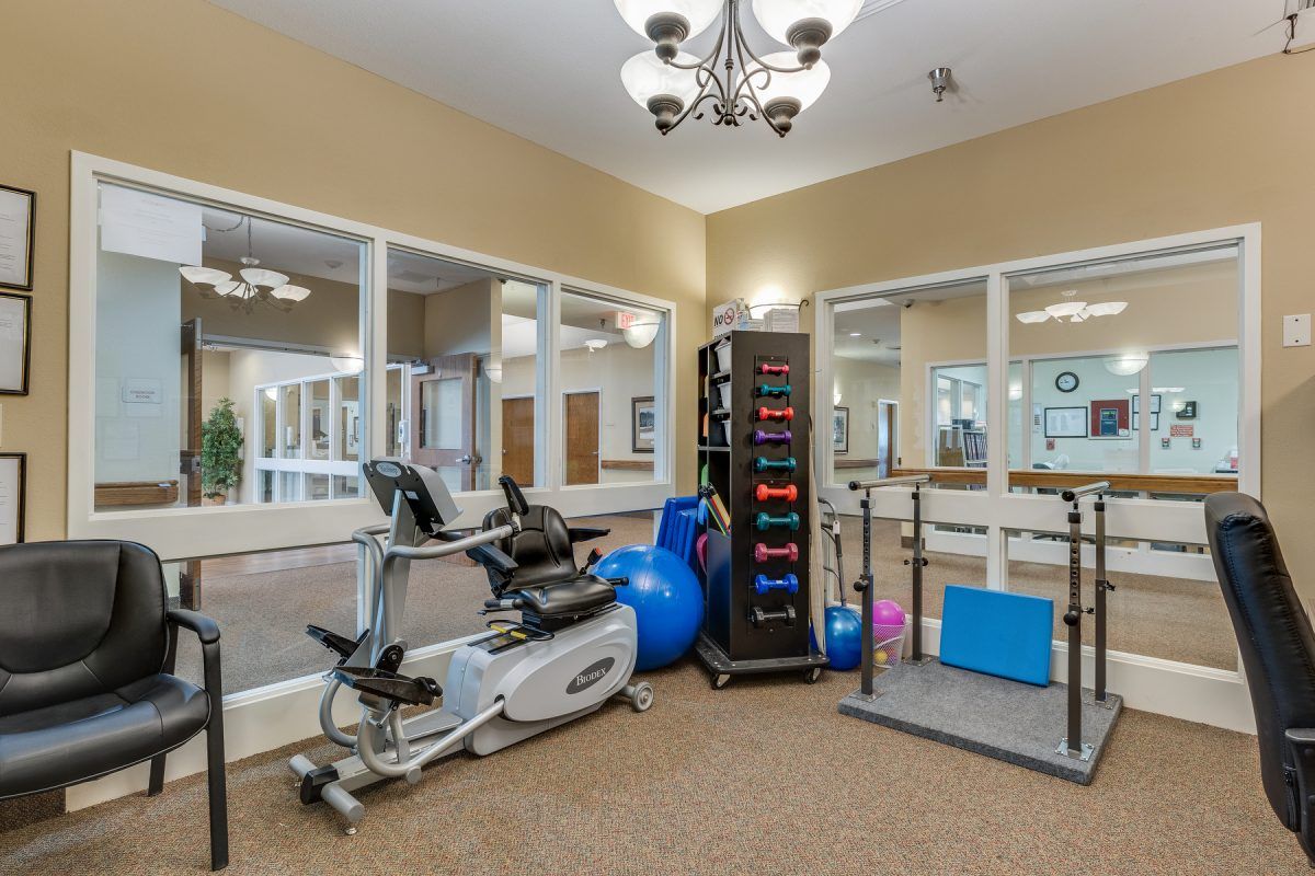 A fitness room equipped with stationary bikes, exercise balls, and fitness mats.