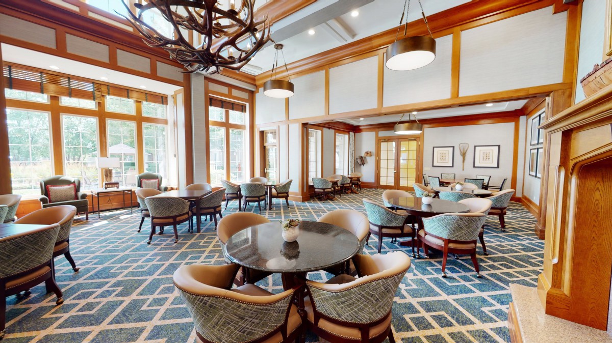 A spacious dining area with elegant furniture and large windows.