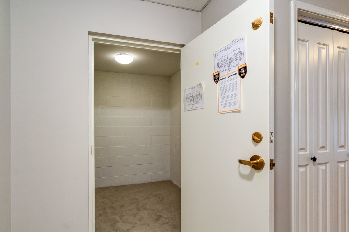 An open door leading to an empty, well-lit room.