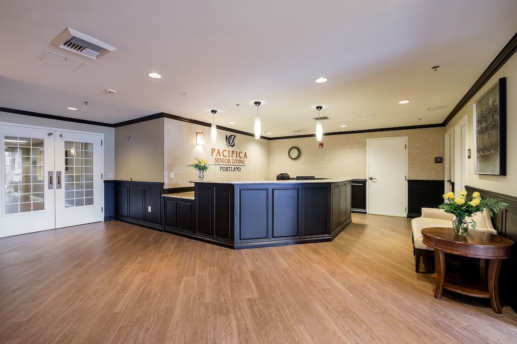 A modern office reception area with a sleek desk and comfortable seating.