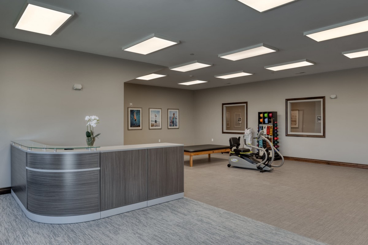 A modern reception area with fitness equipment and a welcoming atmosphere.