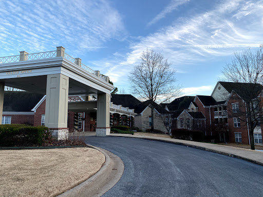 A welcoming entrance to a residential complex under a clear sky.