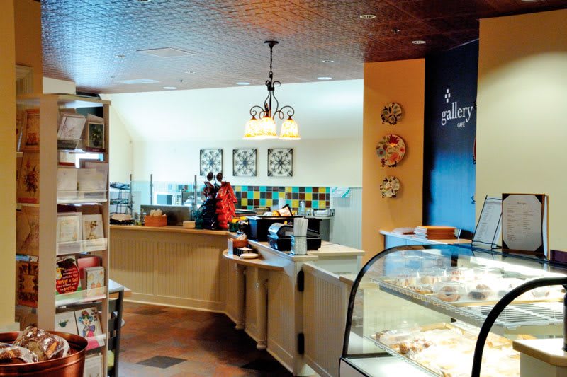 Cozy cafe interior with a counter and pastry display.