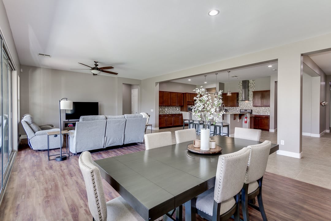 A modern open-floor-plan living space featuring a cozy living room, elegant dining area, and a well-equipped kitchen.