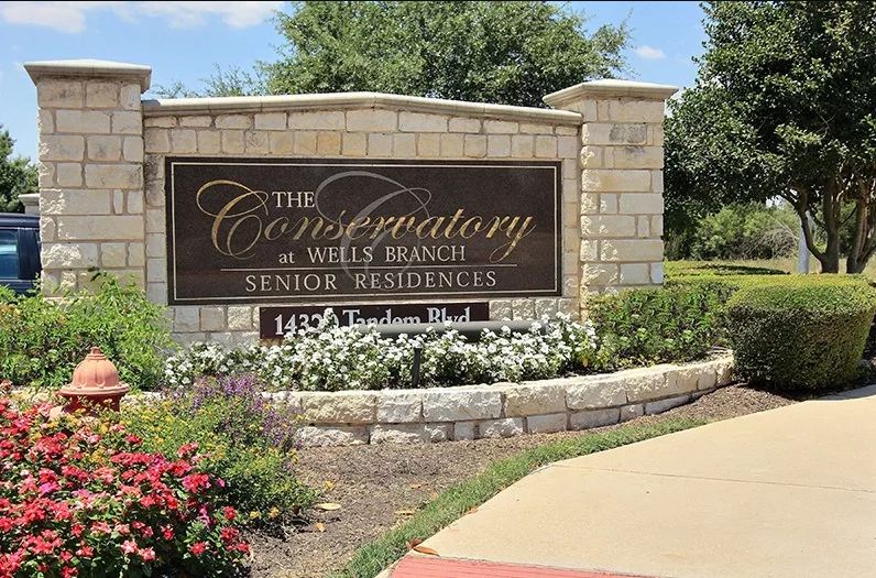 Entrance sign for The Conservatory at Wells Branch Senior Residences.