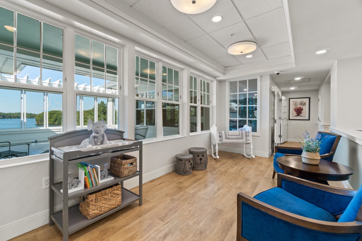 A modern office waiting area with comfortable seating and large windows.