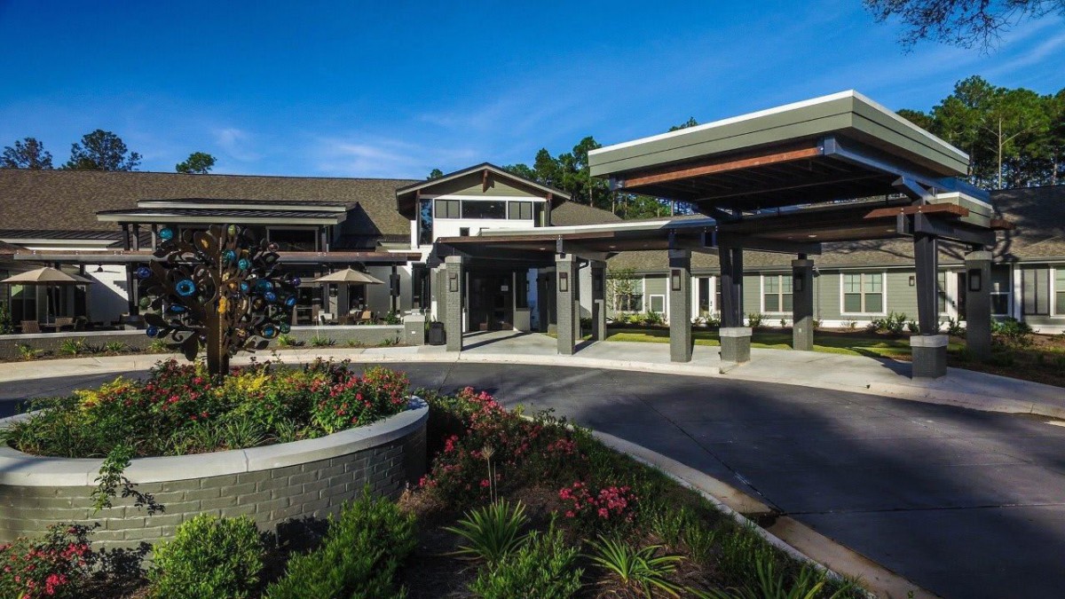 Modern building entrance with landscaped garden.