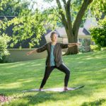 A person practicing yoga outdoors on a sunny day.