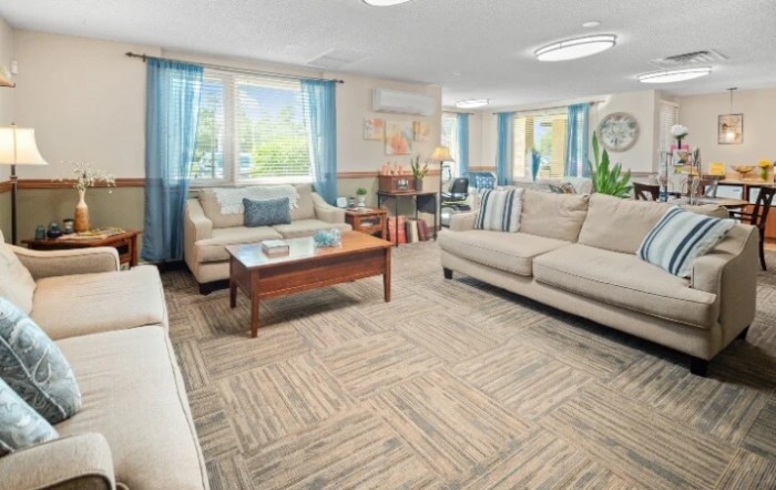 A cozy and well-lit living room with comfortable furniture and tasteful decor.