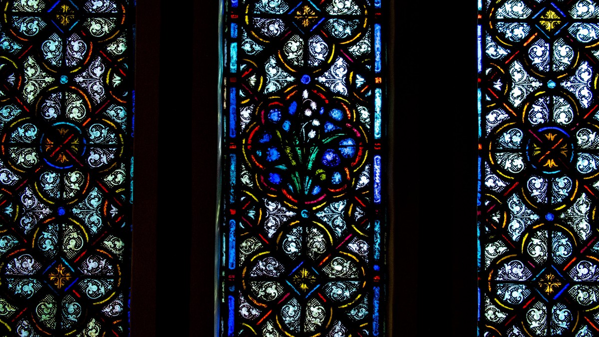 A beautifully intricate stained glass window with a colorful and decorative pattern.