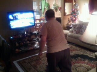 A person playing a video game in the living room.