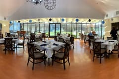 A spacious restaurant dining area with modern decor and abundant natural light.