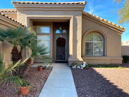 A welcoming entrance to a beautifully landscaped home.