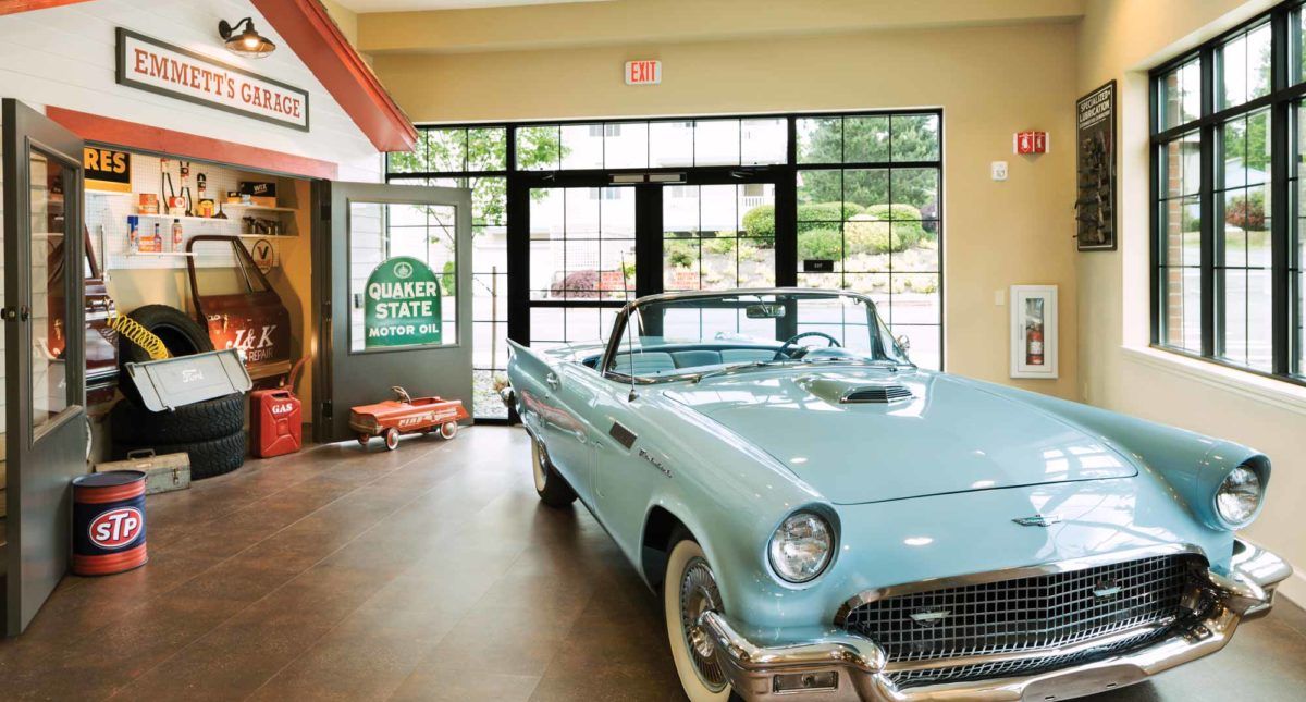 A vintage convertible displayed indoors in a showroom.