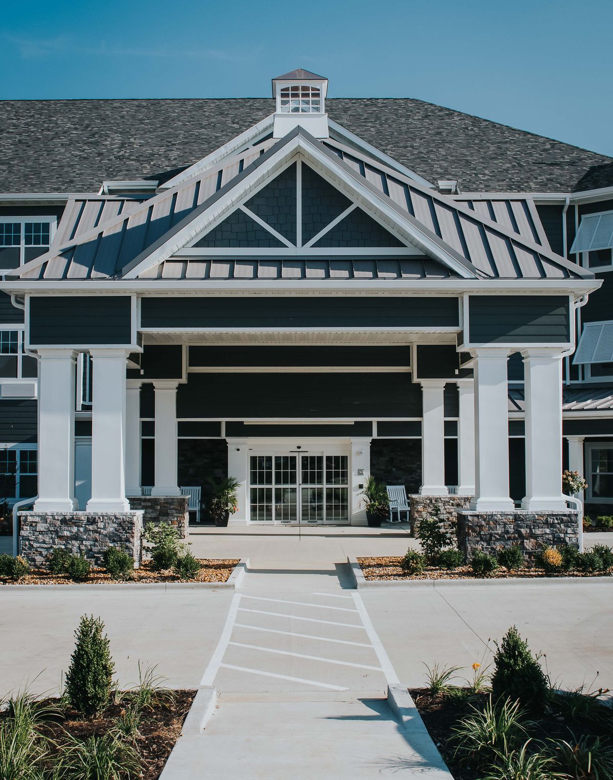A modern residential building with a grand entrance.