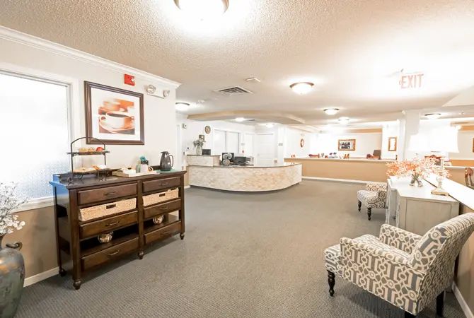 A well-lit reception lobby with modern furniture and a welcoming atmosphere.