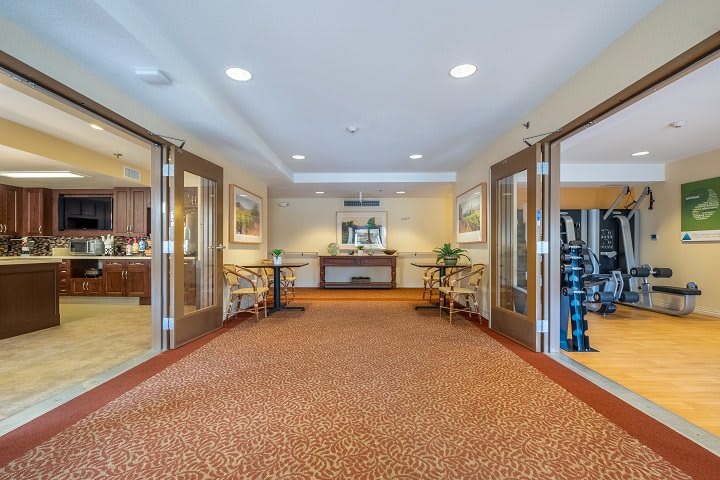 A welcoming hotel lobby with open doors, comfortable seating, and elegant decor.