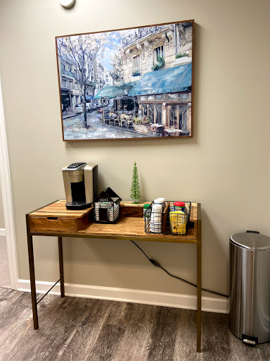 A cozy corner featuring a coffee station with an artistic backdrop.