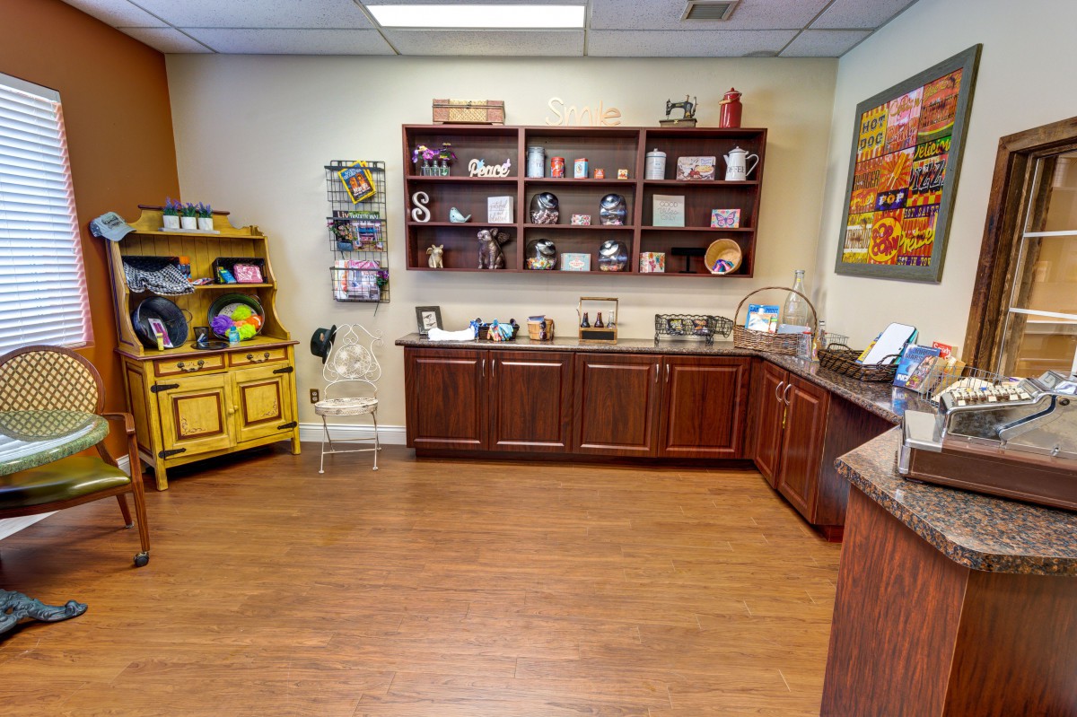 A cozy interior space featuring wooden cabinets and shelves displaying various decorative items.