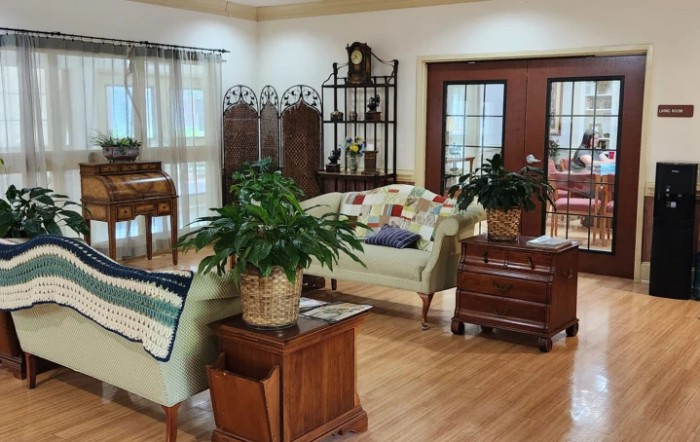 A cozy living room with elegant furniture and indoor plants.