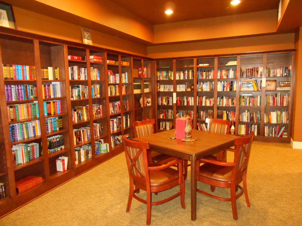 A cozy library corner with bookshelves and a reading table.