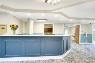 Modern reception area with a blue counter and stylish lighting.