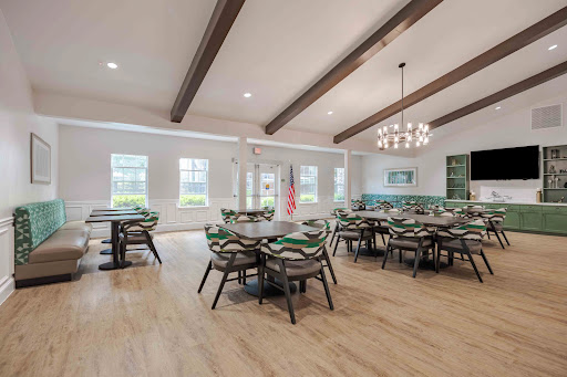 A modern dining area featuring elegant wooden beams and ample natural light, perfect for gatherings.