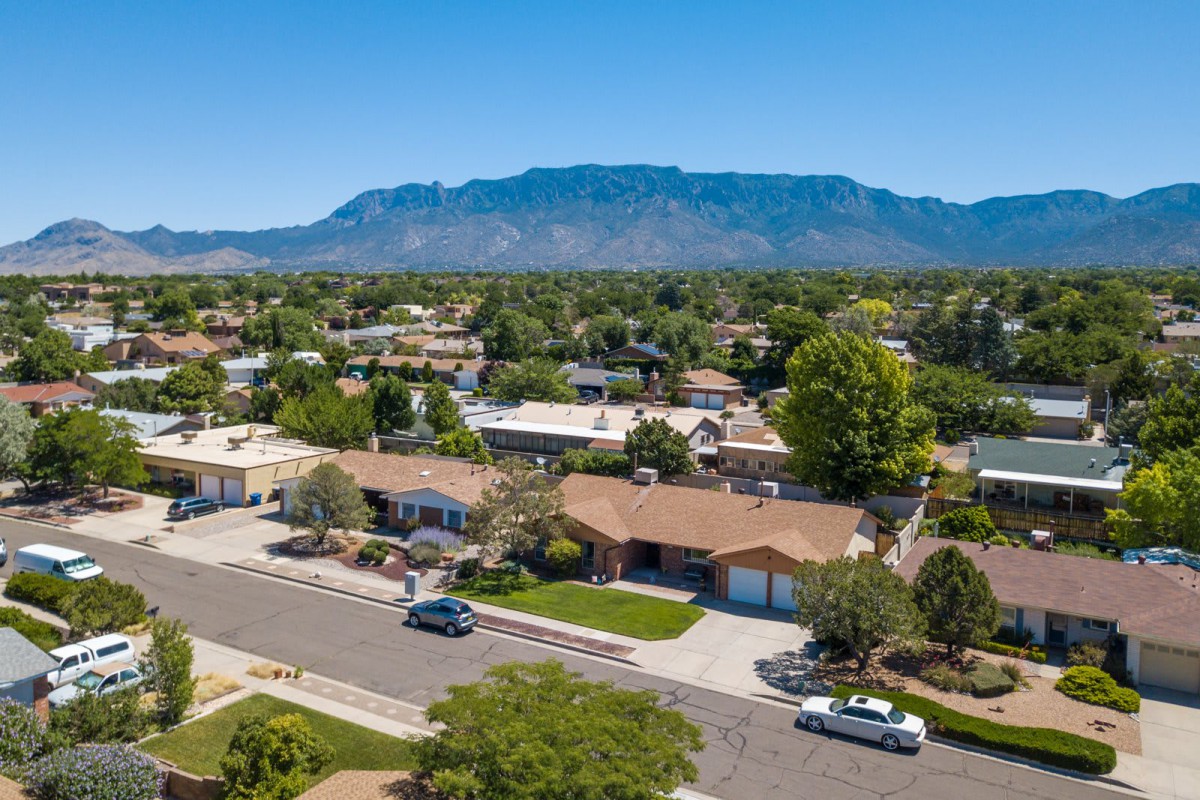 Aerial view of a suburban neighborhood with mountains in the background.