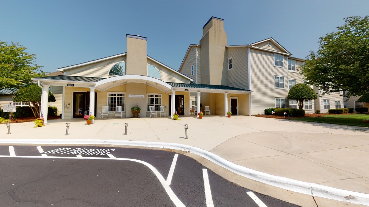A well-maintained building entrance with a covered driveway.