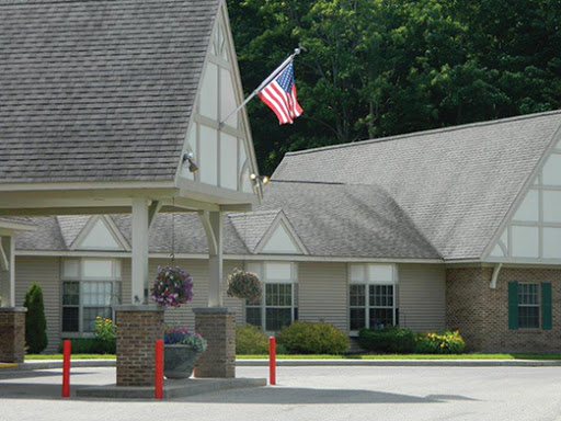 A charming residential building featuring an American flag in the foreground.