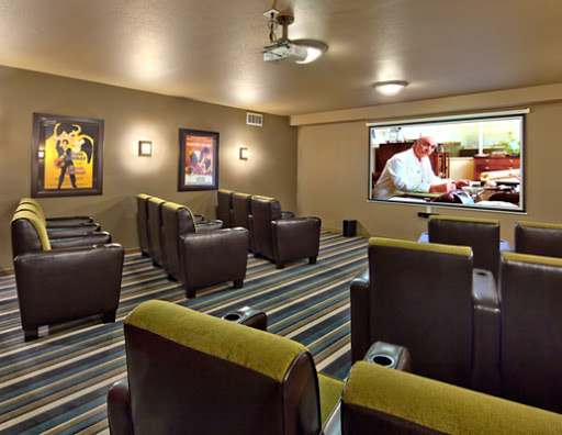 A cozy home theater setup featuring comfortable seating and a large screen.