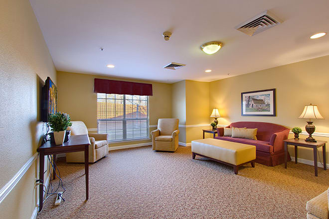 A cozy living room with comfortable seating and warm lighting.
