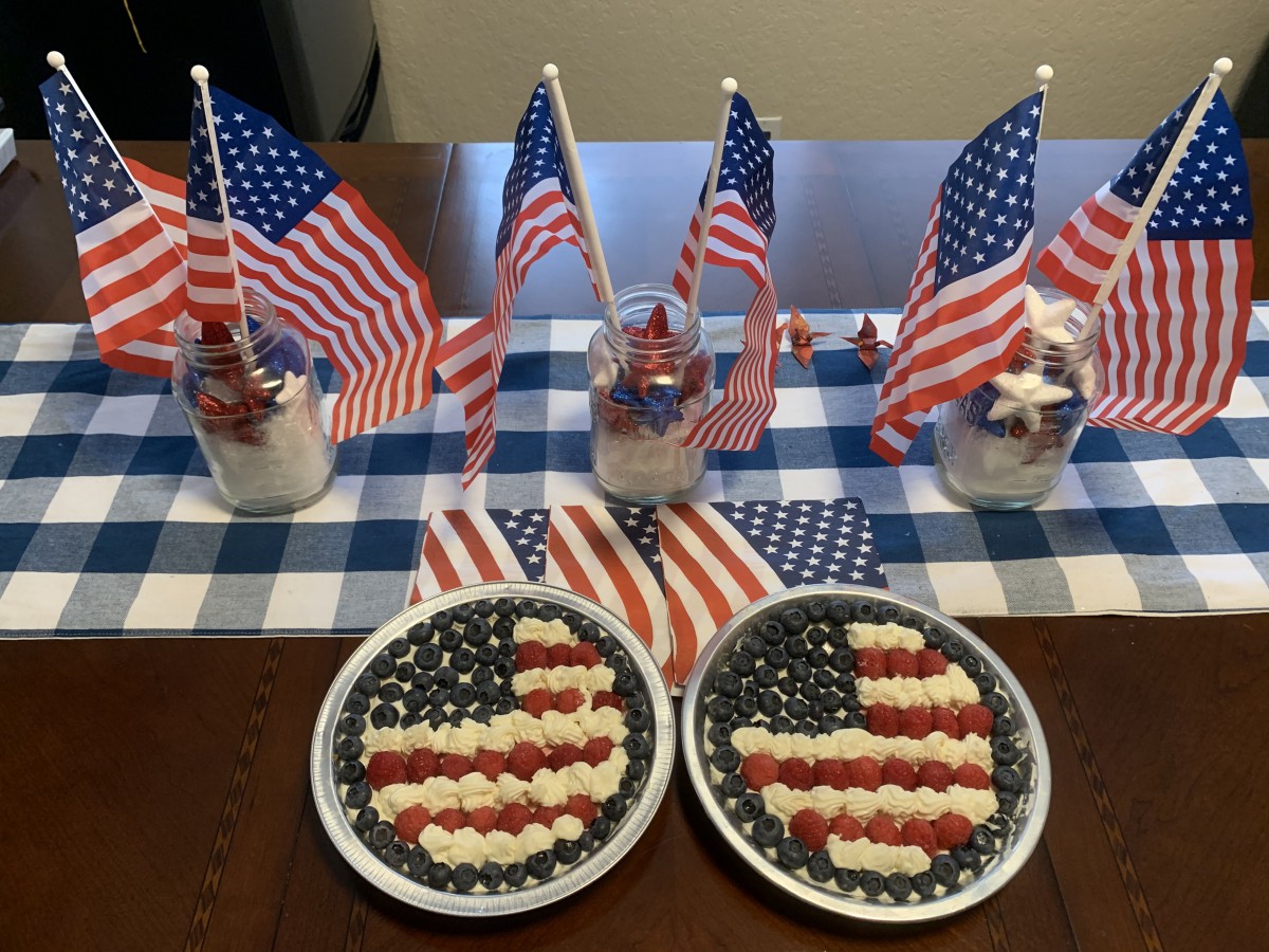 A festive table setup featuring American flag-themed desserts and decorations.