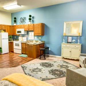 A cozy open-plan kitchen and living room with warm wooden accents and stylish decor.