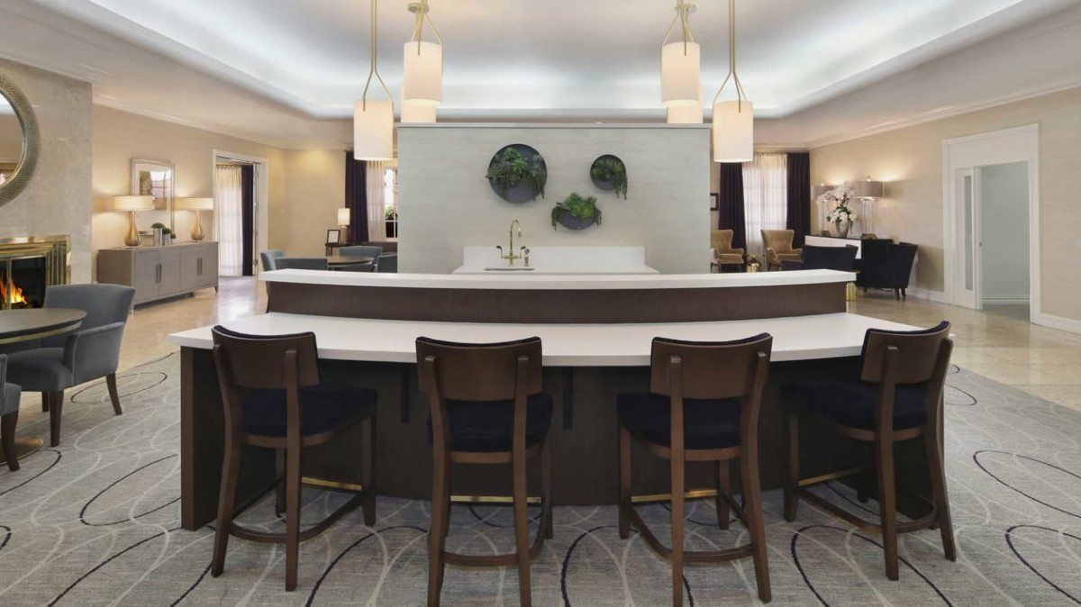 A modern bar area with stylish seating and elegant lighting fixtures.