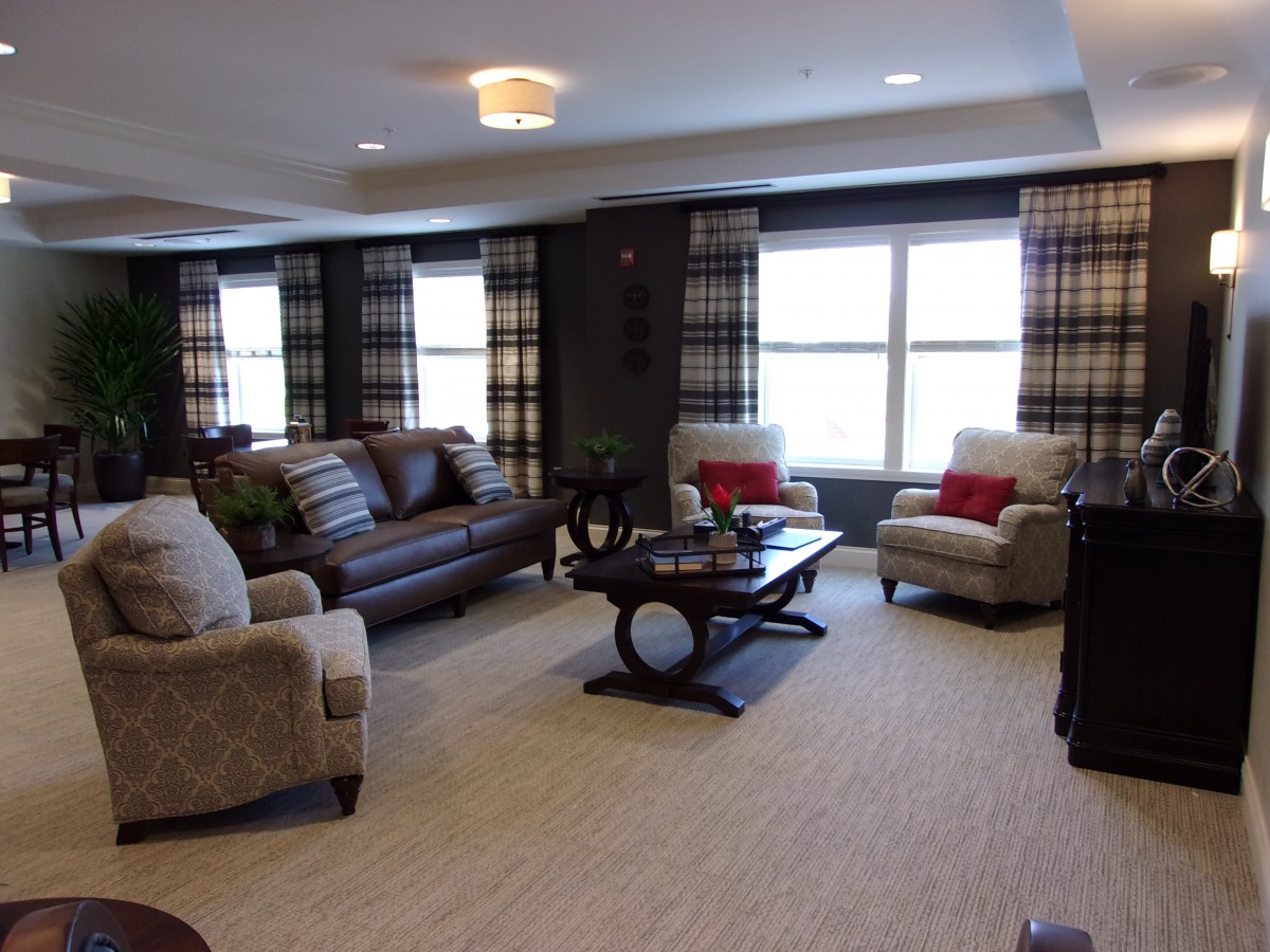 A cozy living room with comfortable seating and plaid curtains.