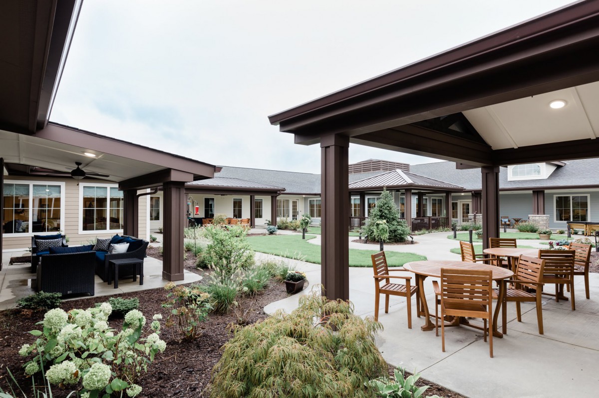 A well-maintained courtyard with outdoor seating and lush landscaping.