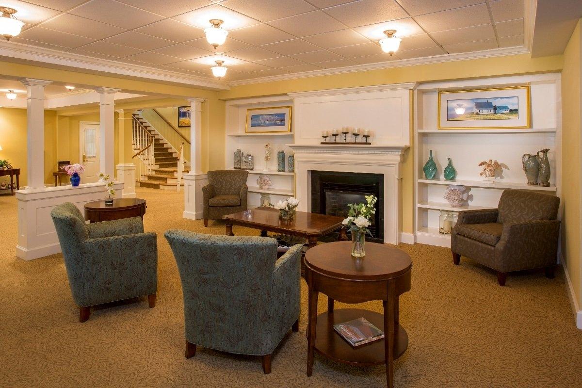 A cozy living room with comfortable armchairs, a fireplace, and well-arranged furniture.