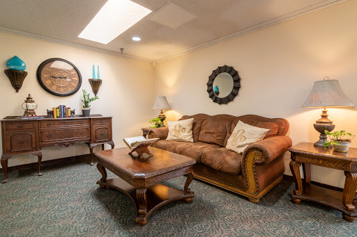 A cozy living room featuring a comfortable sofa and ornate coffee table.