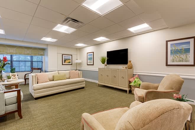 A cozy living room with comfortable seating, a flat-screen TV, and tasteful decor.