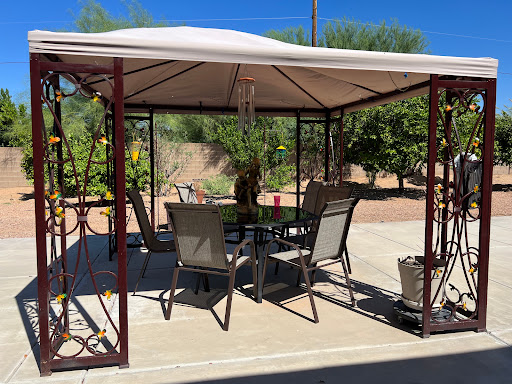 A cozy outdoor gazebo set up for relaxation with comfortable furniture.