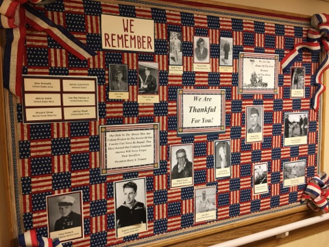 A memorial display honoring military veterans, featuring photographs and a patriotic theme.