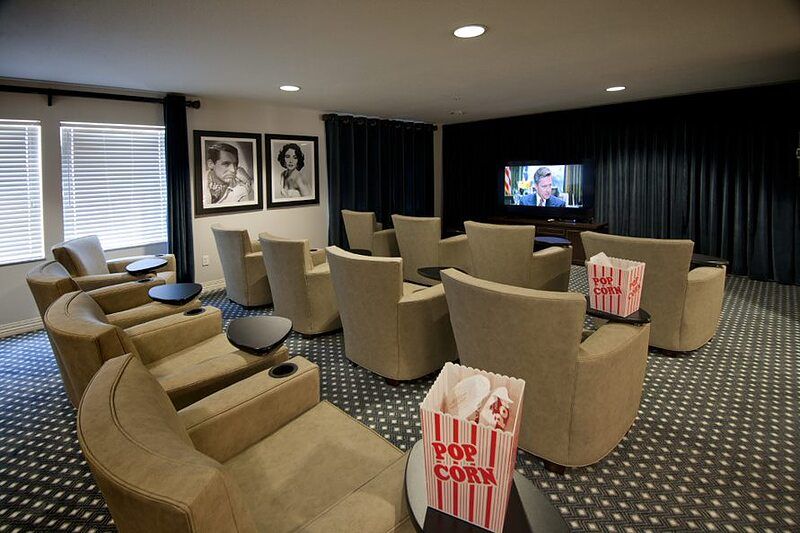 A cozy home theater setup with comfortable seating and popcorn ready for a movie night.