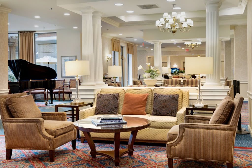 A stylish and elegantly furnished living room with a sofa, chairs, and a coffee table in a cozy setting.