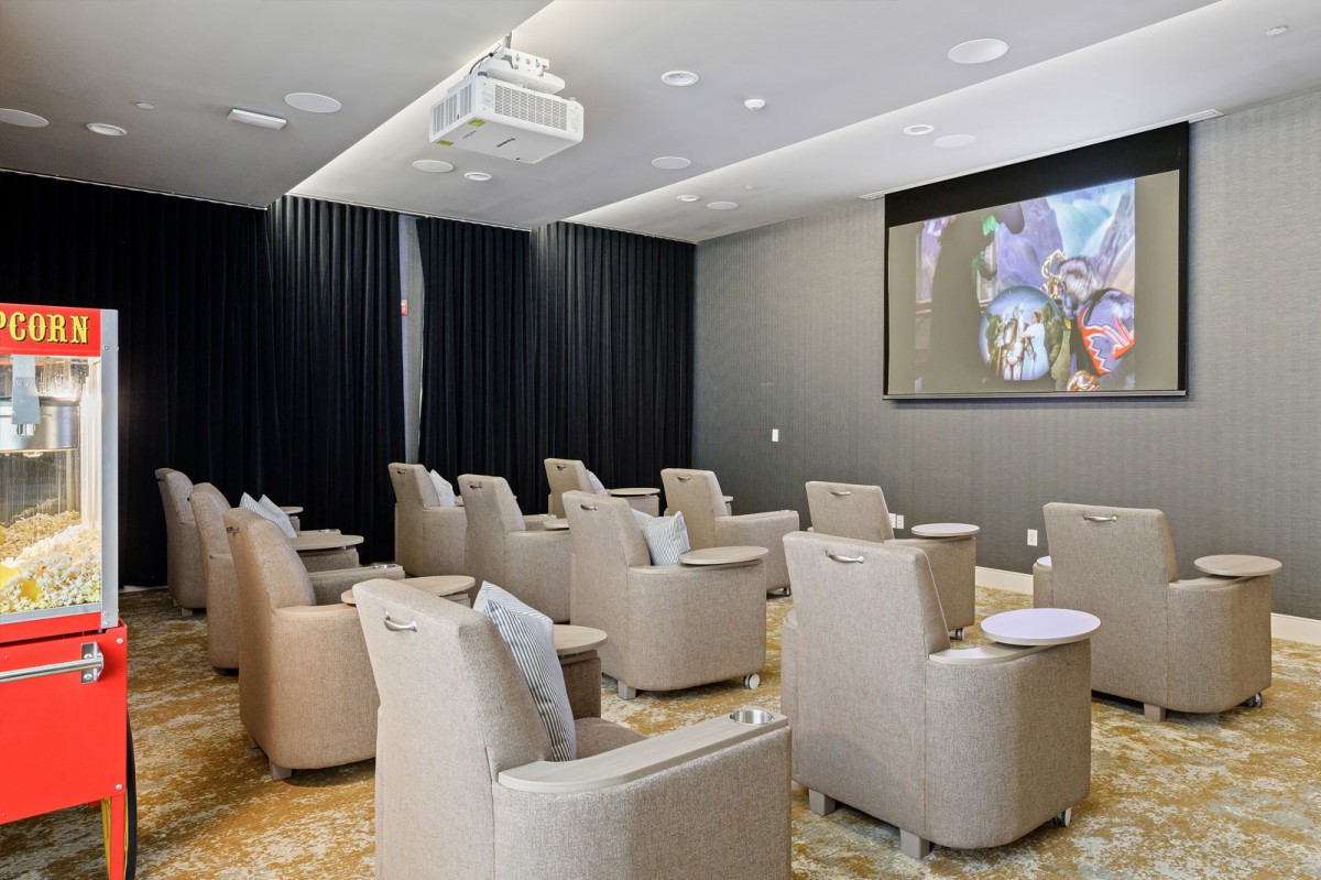 A cozy home theater setup with comfortable seating and a large screen.
