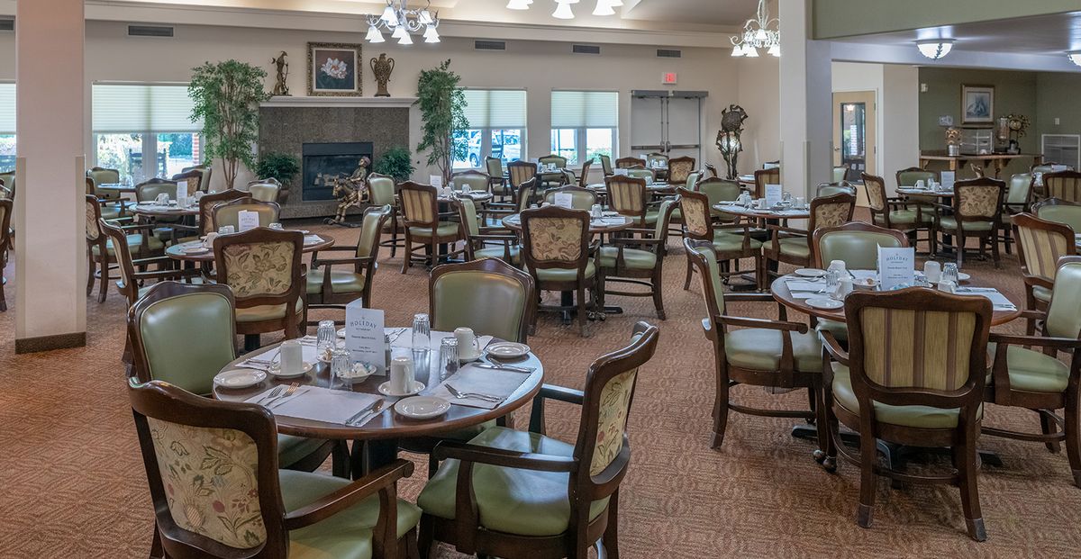 A spacious and elegantly decorated dining area with neatly arranged tables and chairs.